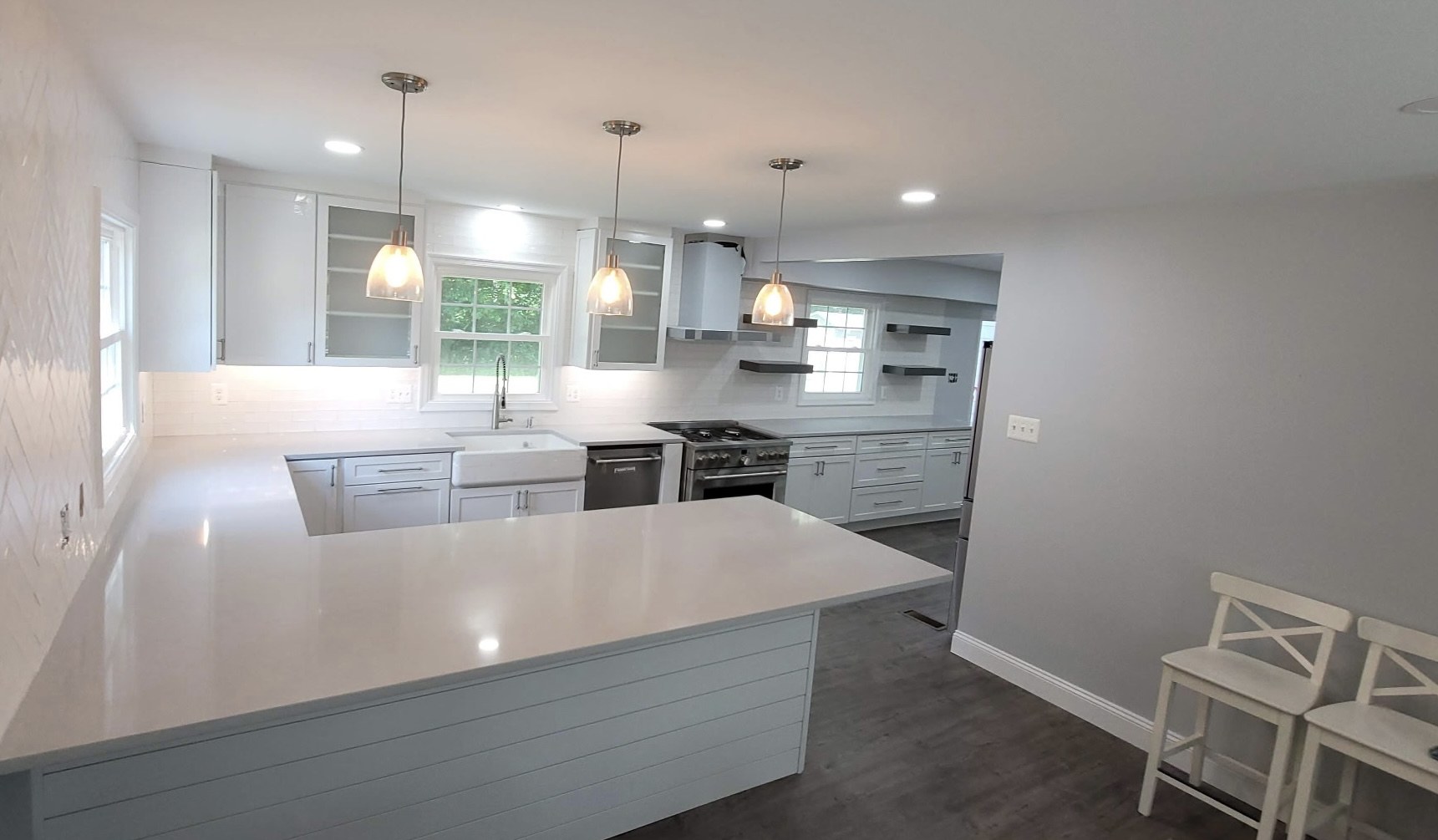 White quartz island kitchen with pendant lighting